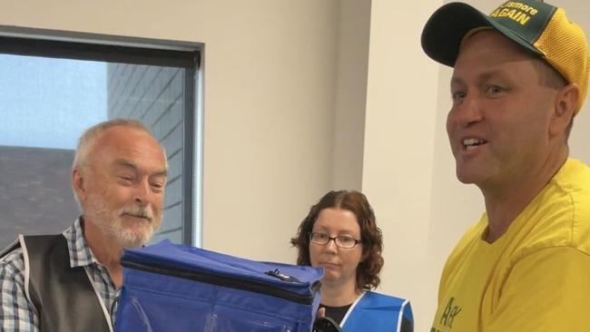 Nationals candidate for the seat of Lismore Alex Rubin of Tenterfield gives the ballot box a lucky shake.