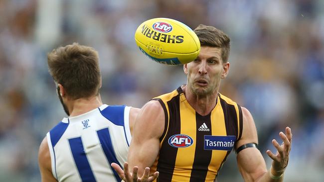 AFL. Round 3. 07/04/2019. Hawthorn v North Melbourne at the MCG. Hawthorn's Luke Breust marks over North Melbourne's Luke McDonald 4th qtr . Pic: Michael Klein.