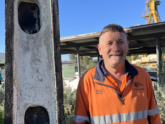 Brian Docking, Stobie Pole Manufacturing Co-Ordinator at SA Power Networks, Angle Park. He’s standing next to the original Stobie Pole from 1924. Picture: Peter Goers