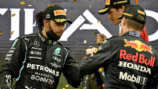 (fromL) Second-placed Mercedes' British driver Lewis Hamilton, 2021 FIA Formula One World Champion Red Bull's Dutch driver Max Verstappen