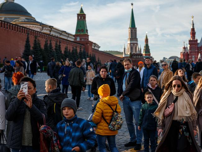 People walk through the Red Square in a sunny autumn day in Moscow as Russisa reports record Covid-19 infections and deaths. Picture: AFP