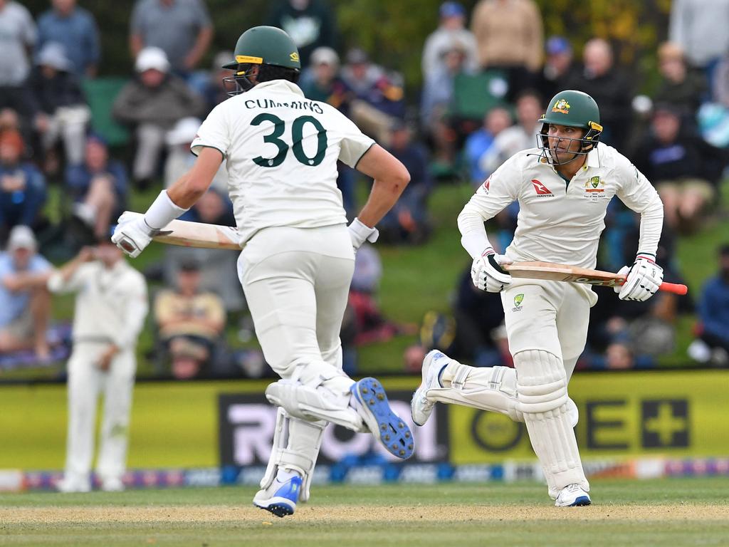 Australia's Pat Cummins (L) and Alex Carey chip away at the target. Picture: AFP