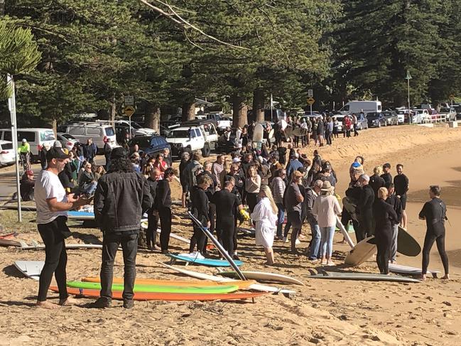 Family and friends of Mark Sanguinetti gather at the south end of Palm Beach – Kiddies Corner – before the paddle out ceremony to honour the passionate surfer's memory. Picture: Jim O'Rourke