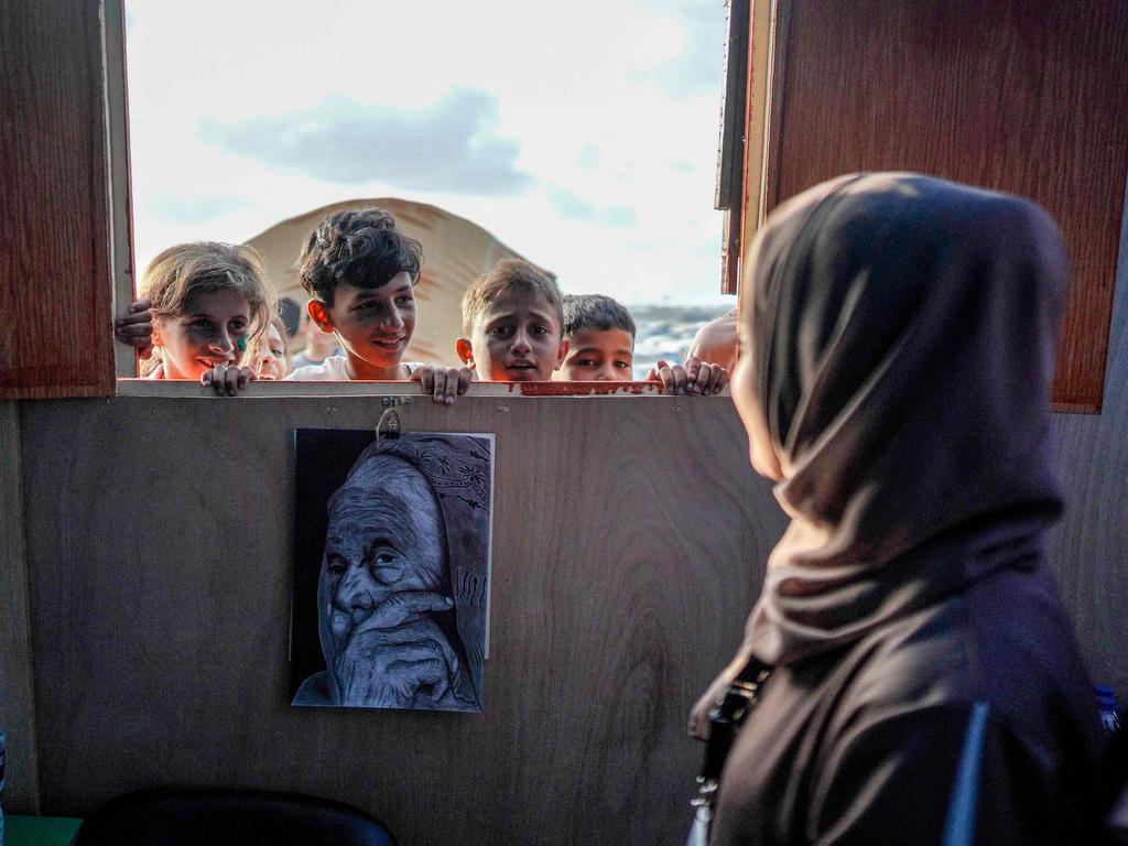 Children attend class at a makeshift school in a camp for displaced Palestinians in Deir El-Balah, in the central Gaza Strip. Picture: AFP