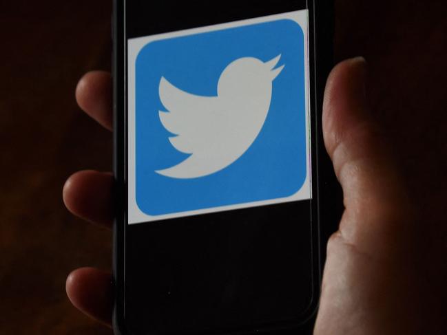 (FILES) In this file illustration photo taken on May 27, 2020 a Twitter logo is displayed on a mobile phone in Arlington, Virginia. - Twitter said on May 20, 2021 it was revamping its rules for verified accounts, potentially opening up the coveted blue badge to more users, but with clearer guidelines. Updated procedures will make it easier for Twitter users to request certification, but the platform will also remove the badge for those without certain requirements, as well as for those violating Twitter's rules. (Photo by Olivier DOULIERY / AFP)