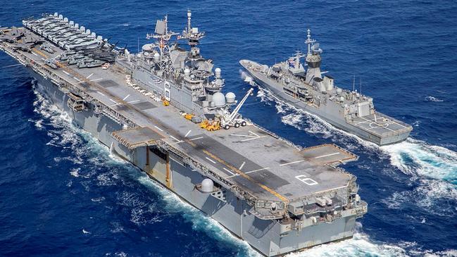 Royal Australian Navy frigate, the HMAS Ballarat (right) and USS America conduct a replenishment at sea off the coat of Queensland, during Exercise Talisman Sabre 2021. Picture: LSIS Ernesto Sanchez