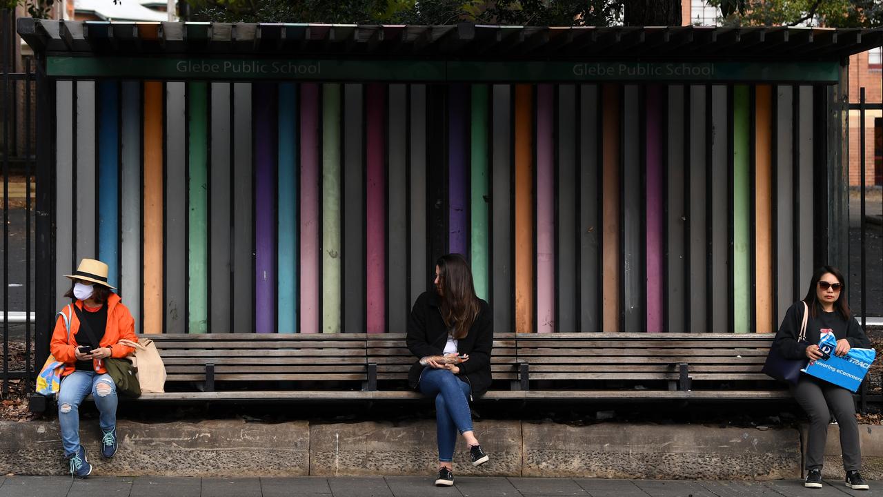 People social distance at a bus stop at Glebe in Sydney. Melanie has gone a step further than maintaining social distance — she’s been in a stage three lockdown by choice for months. Picture: NCA NewsWire/Joel Carrett