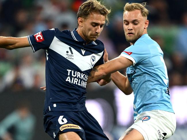 MELBOURNE, AUSTRALIA - OCTOBER 26: Ryan Teague of Melbourne Victory and Nathaniel Atkinson of Melbourne City compete for the ball during the round two A-League Men match between Melbourne City and Melbourne Victory at AAMI Park, on October 26, 2024, in Melbourne, Australia. (Photo by Quinn Rooney/Getty Images)