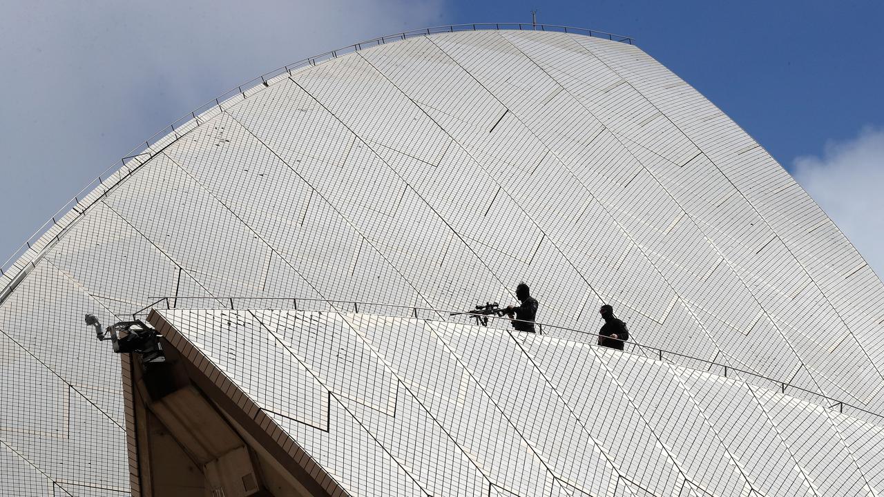 Police snipers are seen on the Sydney Opera House as they prepare for the arrival of Prince Harry, Duke of Sussex, and Meghan, Duchess of Sussex.