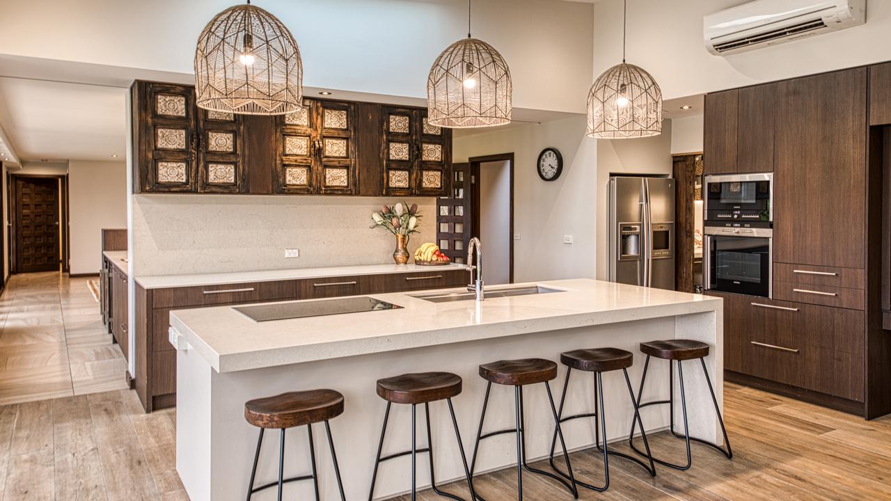 Cesar stone benchtops, two dishwashers, and an induction cooktop can be found in the kitchen.