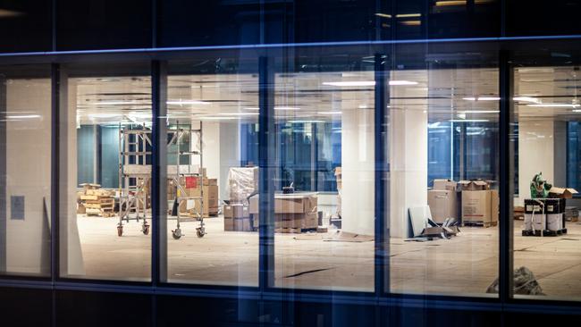 Construction renovation of new office in business building window at night; empty office space generic