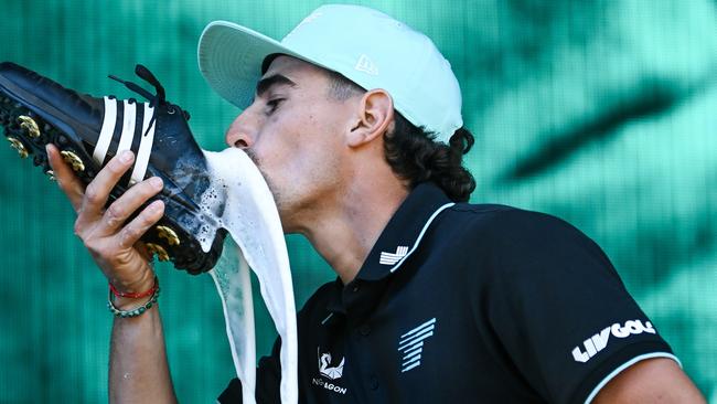 ADELAIDE, AUSTRALIA - FEBRUARY 16: Joaquin Niemann of Torque celebrates with a shoey on stage after winning the  LIV Golf Adelaide at The Grange Golf Club on February 16, 2025 in Adelaide, Australia. (Photo by Mark Brake/Getty Images)