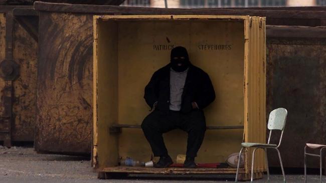 A security guard wearing a balaclava at the gate of Patrick's terminal in Fremantle, Western Australia in 1998. Picture: Tony McDonough