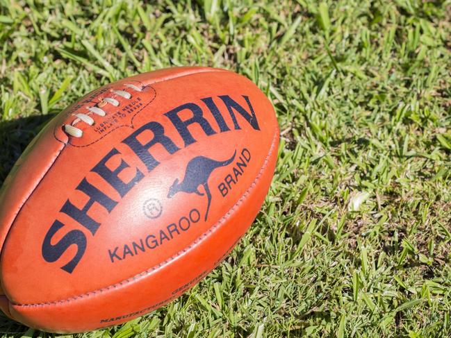 "Lismore, NSW, Australia - May 9, 2012: A Kangaroo Brand Sherrin football sits on grass. This is the official ball of AFL, Australian Rules Football, and has been used since the 1880s"