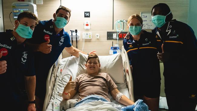 Melbourne Storm players Harry Grant, Dale Finucane, patient Jett Jones, Sunshine Coast Lightning’s Maddie McAuliffe and Phumza Maweni during a visit to the Sunshine Coast University Hospital.​