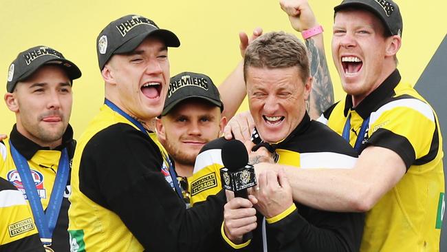 Dustin Martin and Jack Riewoldt make their affection for coach Damien Hardwick clear after last year’s Grand Final win.