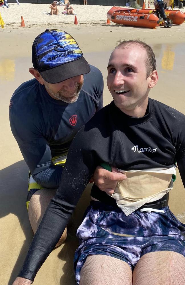 Mr Brace and his son Chris at the beach in the years after the accident. Picture: Facebook