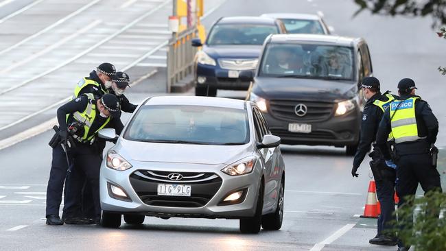 Police trying to stop the woman’s car outside the Racecourse Rd public housing towers. Picture: David Crosling