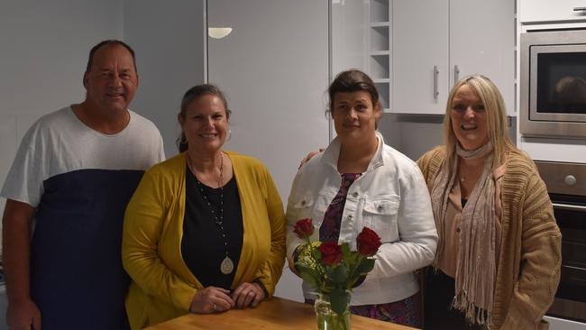 Rex, Linda and daughter Allyce Cunningham with Fiona Moseley in the kitchen of their new unit complex.