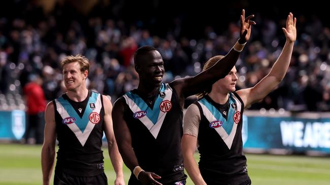 Tom Jonas, Aliir Aliir and Miles Bergman celebrate Port Adelaide’s win over Geeling. Picture: James Elsby/AFL Photos