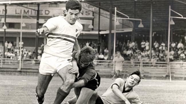 Former Socceroo captain and football legend Johnny Warren (left) in his playing heyday.