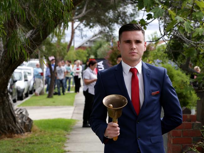 Prospective buyers inspect a Hocking Stuart property before an auction. Picture: Mark Dadswell