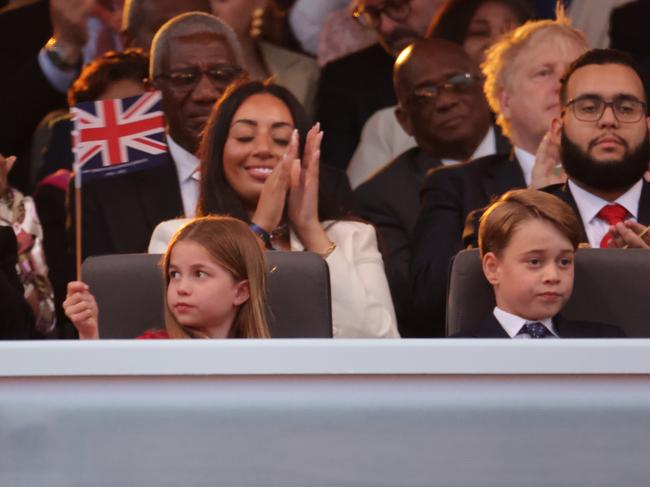 Princess Charlotte, left, looked hilariously unimpressed at times during the concert. Picture: Getty Images