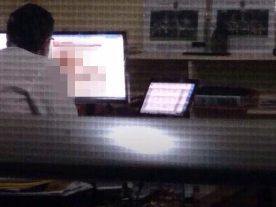 This photograph, believed to show the then Geelong College principal watching pornography in his office, was widely circulated on social media.