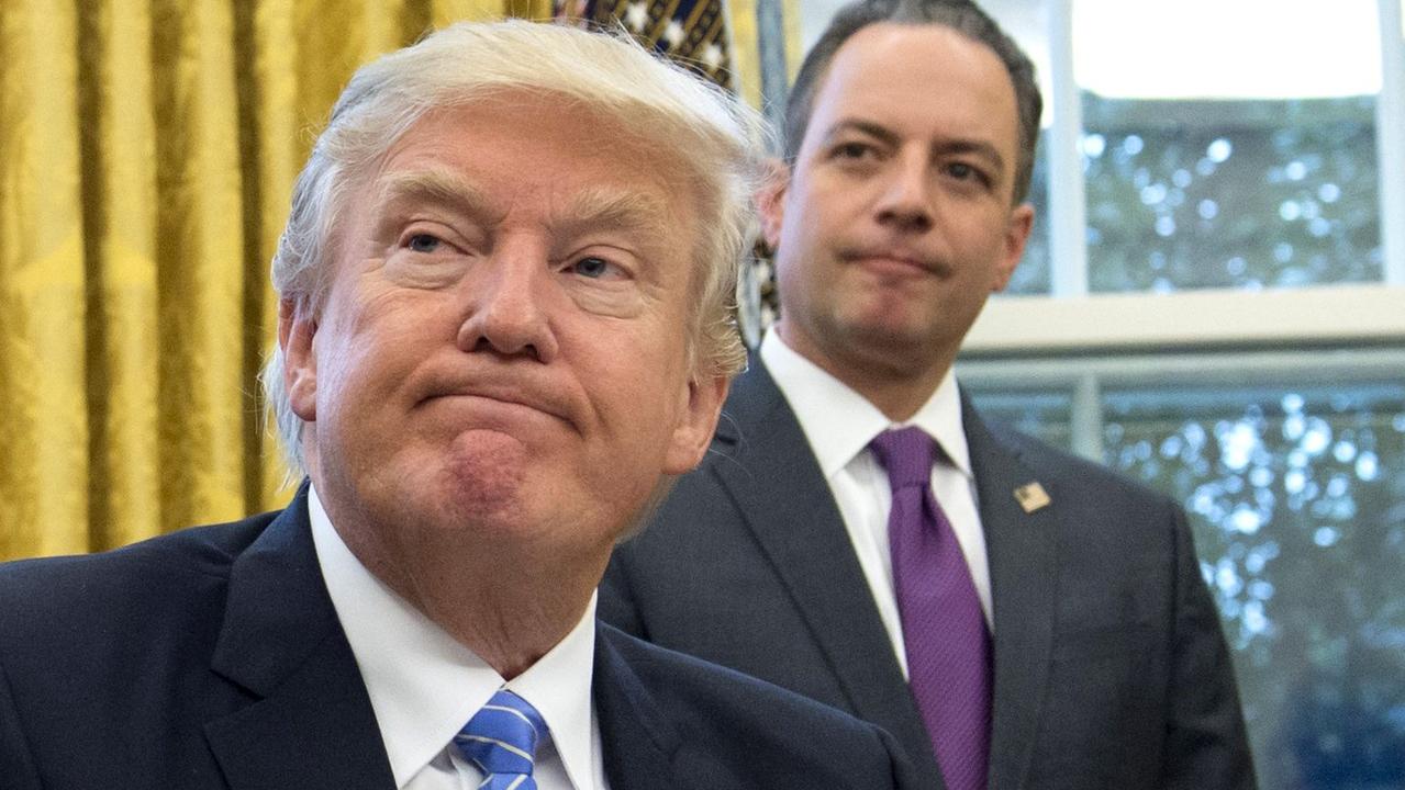 Mr Priebus standing behind then-president Donald Trump’s shoulder in the Oval Office. Picture: Saul Loeb/AFP