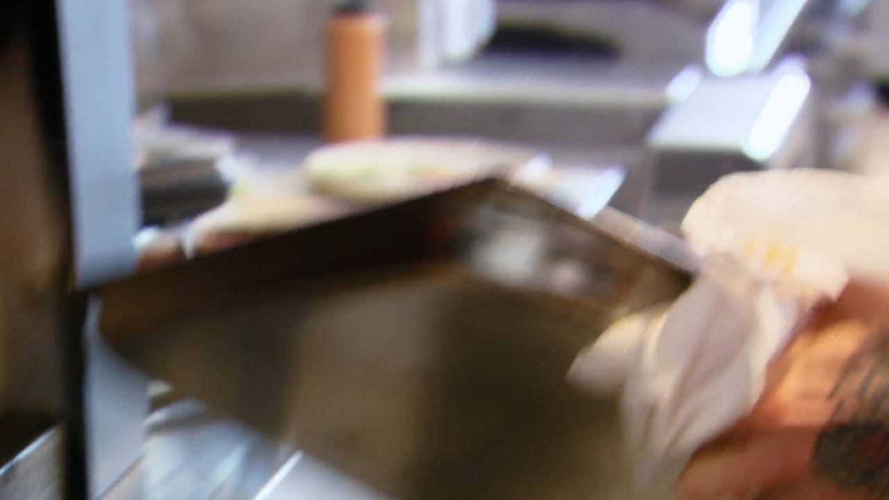 Pete is very close to dropping an entire tray of cooked octopus. Picture: Channel 10