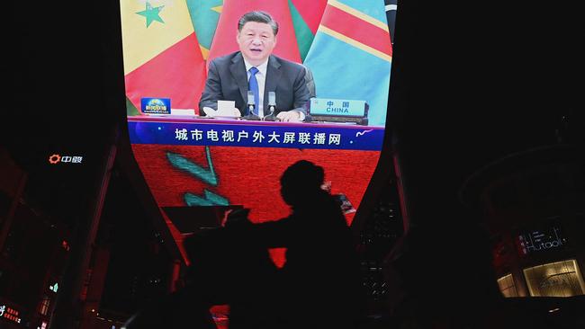 China's President Xi Jinping during an evening news program, showing his keynote speech at the opening ceremony of the 8th Forum on China-Africa Cooperation at a mall in Beijing on November 30. Picture: AFP