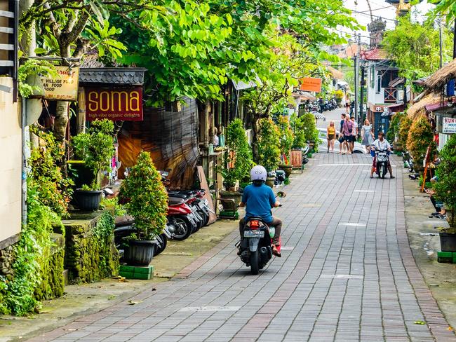 Tourists strolling along the central street of Ubud. Ubud is the cultural heart of Bali. It's full of restaurants, yoga studios, spaÃ¢â‚¬â„¢s and shops. This traditional country town is home to one of Bali's royal families.Escape 7 January 2024Eds LetterPhoto - iStock