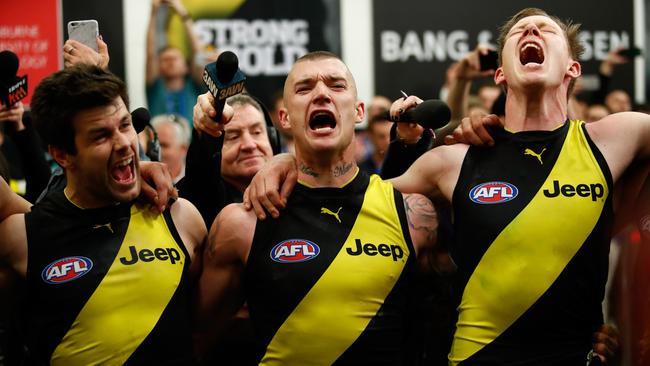 Trent Cotchin, Dustin Martin and Jack Riewoldt of sing the team song after winning last year’s preliminary final. (Photo by Adam Trafford/AFL Media/Getty Images)