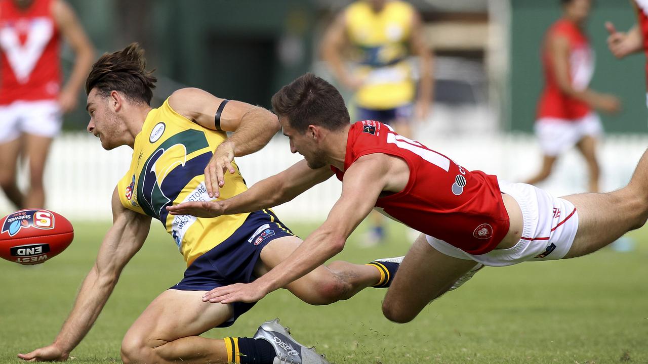 SANFL: Eagles v North Adelaide at Woodville Oval. North's Tom Schwarz dives for the ball with Eagle's Jordan Foote. 31 March 2019. (AAP Image/Dean Martin)