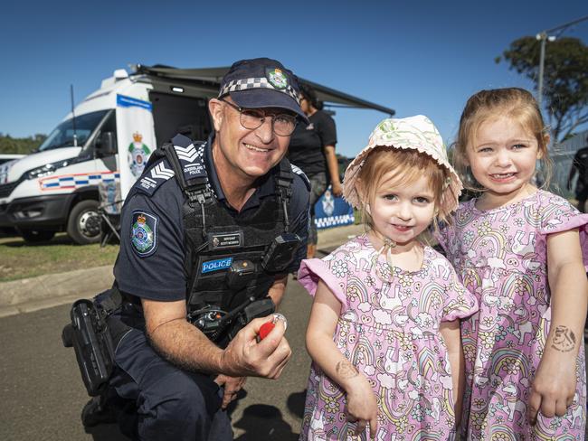 Rayner and Candice (right) Glozier get stamps from Darling Downs District Crime Prevention coordinator Sergeant Scott McGrath in front of the Mobile Police Beat at the Toowoomba Royal Show, Friday, April 19, 2024. Picture: Kevin Farmer