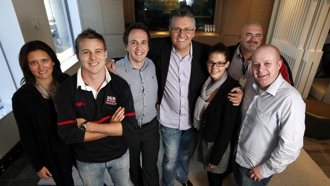 Ray Hadley (centre) and Chris Bowen (right) celebrating a ratings award with their team in the Sydney 2GB studio. Mr Bowen resigned earlier this year.