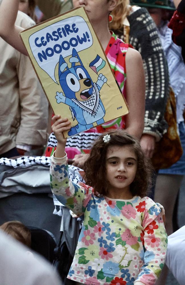 A young girl at the pro-Palestine march holds a sign depicting Bluey. Picture: Liam Kidston