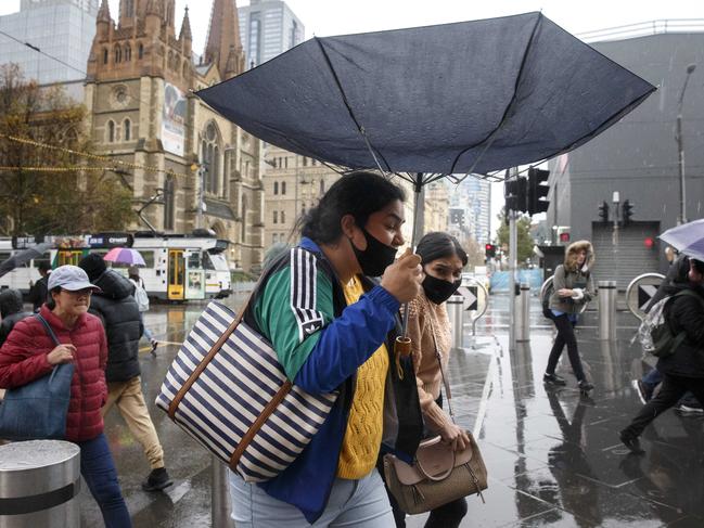 MELBOURNE, AUSTRALIA - NewsWire Photos MAY 25, 2021: People brave the wet and windy weather in Melbourne on Tuesday afternoon with a severe weather warning in place for damaging wind across parts of the state, including gusts of up to 100km/h.Picture: NCA NewsWire / David Geraghty