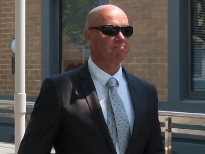 James Scott Church (dark suit, sunglasses) leaving Wyong Local Court where he was committed to stand trial for the murder of Leisl Smith at Tuggerah in 2012. Picture: Richard Noone