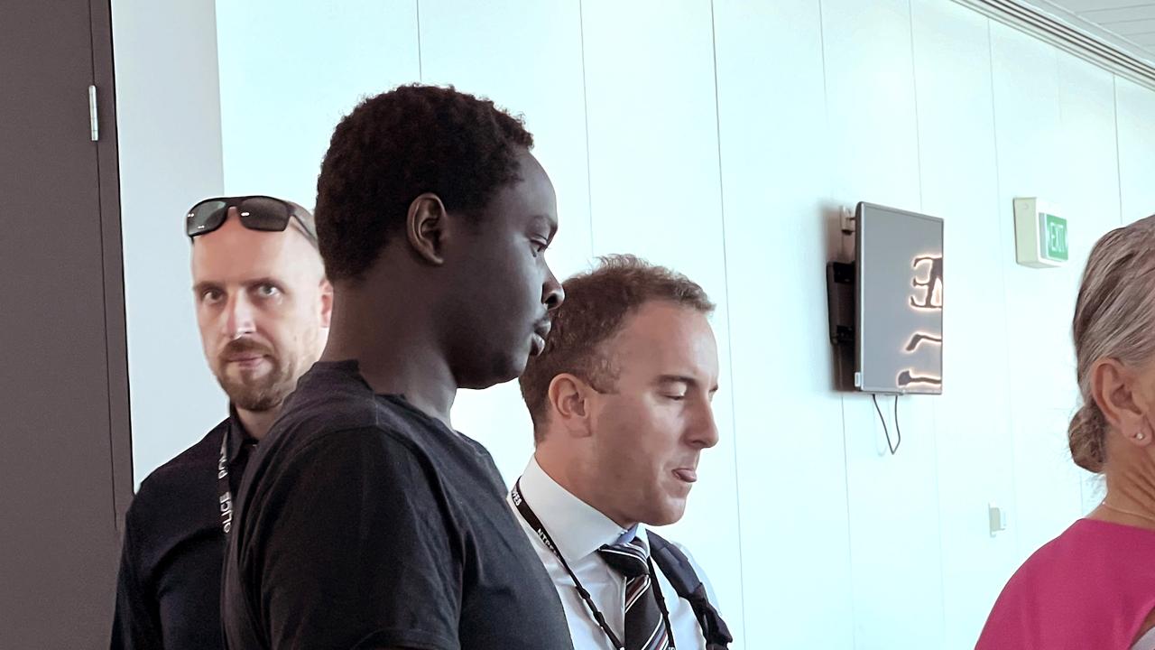 MELBOURNE AUSTRALIA: Accused murderer Koang Wuordol, arrested over the murder of Sudanese teenager Yiel Gatluak, boards a Qantas flight at Melbourne Airport, and is extradited to Alice Springs. PICTURE: NCA Newswire / Nicki Connolly