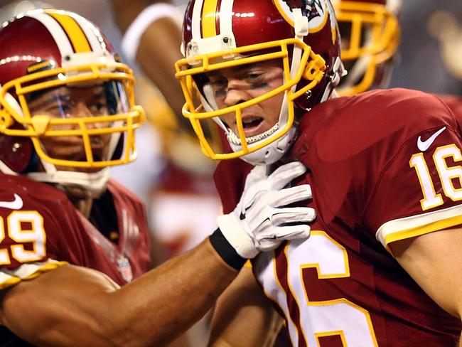 ARLINGTON, TX - OCTOBER 27: Colt McCoy #16 of the Washington Redskins and Roy Helu #29 of the Washington Redskins celebrate McCoy's touchdown against the Dallas Cowboys during the second half at AT&T Stadium on October 27, 2014 in Arlington, Texas. Ronald Martinez/Getty Images/AFP == FOR NEWSPAPERS, INTERNET, TELCOS & TELEVISION USE ONLY ==