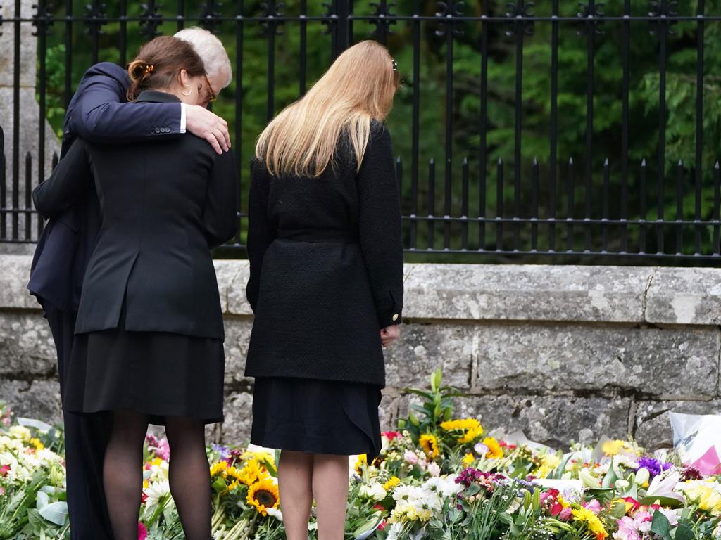 Princess Beatrice of York, Princess Eugenie of York and Prince Andrew, Duke of York look at messages and floral tributes left by members of the public after attending a service at Crathie Kirk church near Balmoral following the death of Queen Elizabeth II. Picture: Owen Humphreys-WPA Pool/Getty Images