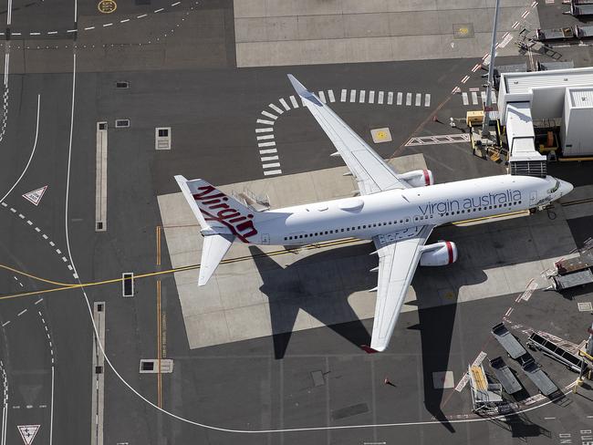 SYDNEY, AUSTRALIA - APRIL 22: An aerial view of the Virgin Australia terminal at Sydney Airport on April 22, 2020 in Sydney, Australia. Restrictions have been placed on all non-essential business and strict social distancing rules are in place across Australia in response to the COVID-19 pandemic.  (Photo by Ryan Pierse/Getty Images)