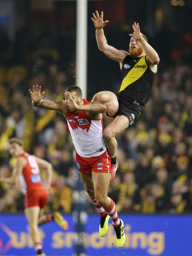 Nick Vlastuin takes a speccie over Lance Franklin. Picture: Michael Klein