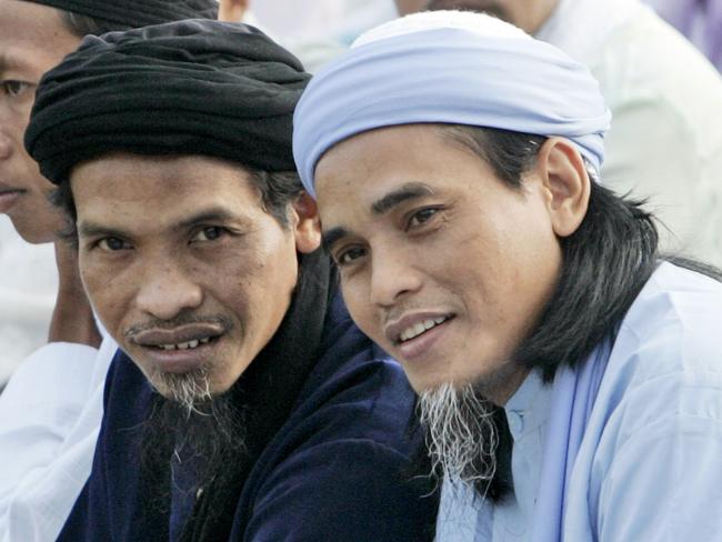 Convicted Bali bombers Amrozi Nurhasyim, right, and Ali Ghufron, who are currently on death row, are seen before the start of Eid al-Fitr prayer marking the end of the holy fasting month of Ramadan at Batu prison on Nusakambangan island, Indonesia, Oct. 1, 2008. (AP Photo/Dita Alangkara)