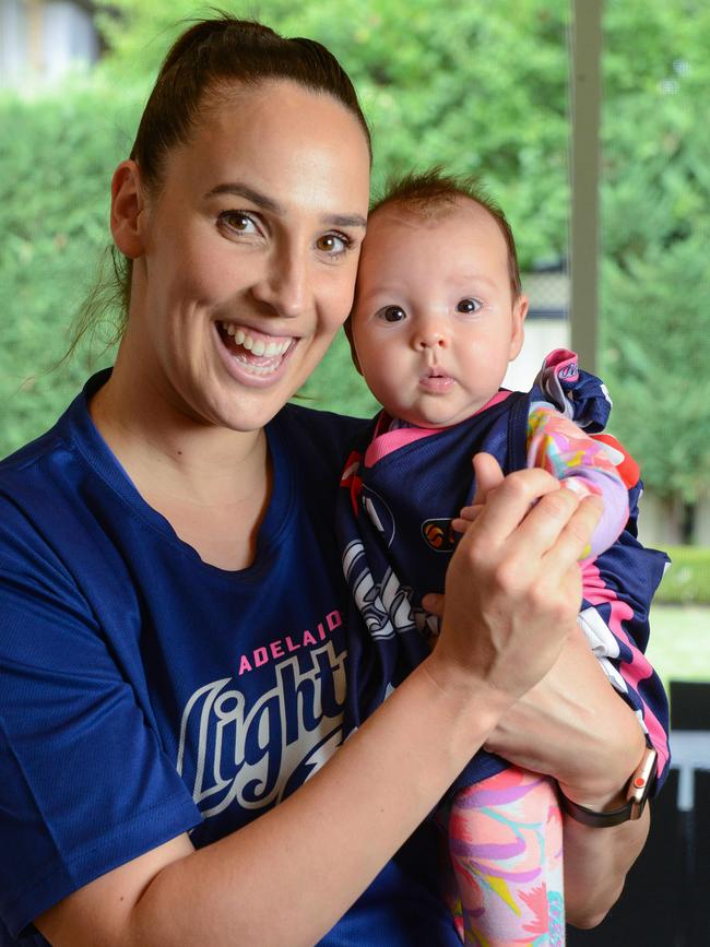 Former Olympic basketballer Laura Hodges with her baby Ava in February. AAP Image/Brenton Edwards)