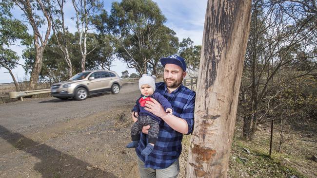 John Dagher, with son Ezra near Masons Rd last year, wants the road to return to being two-way traffic.