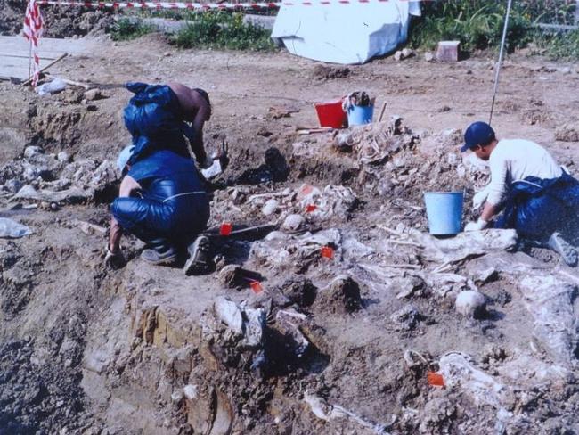 Working on the Srebrenica massacre, in Bosnia, for the United Nations, after thousands of bodies were found in mass graves (as shown above) was one of the cases Dr Chris Lawrence will never forget. Picture Supplied