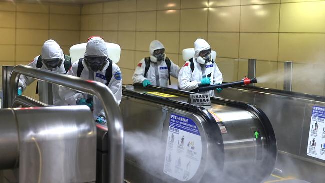 Soldiers disinfect Taipei’s main rail station on Tuesday as Taiwan and Singapore face a resurgence in the number of COVID-19 cases. Picture: Reuters.