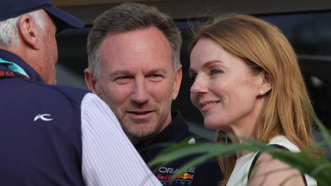 Red Bull Racing team principal Christian Horner and his wife British singer Geri Halliwell talk to an acquaintance ahead of the Bahrain Formula One Grand Prix at the Bahrain International Circuit in Sakhir on March 2, 2024. (Photo by Giuseppe CACACE / AFP)